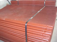 A bundle of red painted spring screen mesh with hook edge.